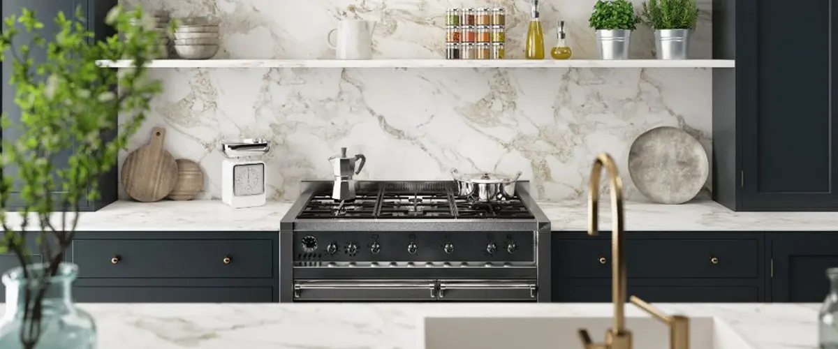 kitchen with blue cabinets and white backsplassh and contertop