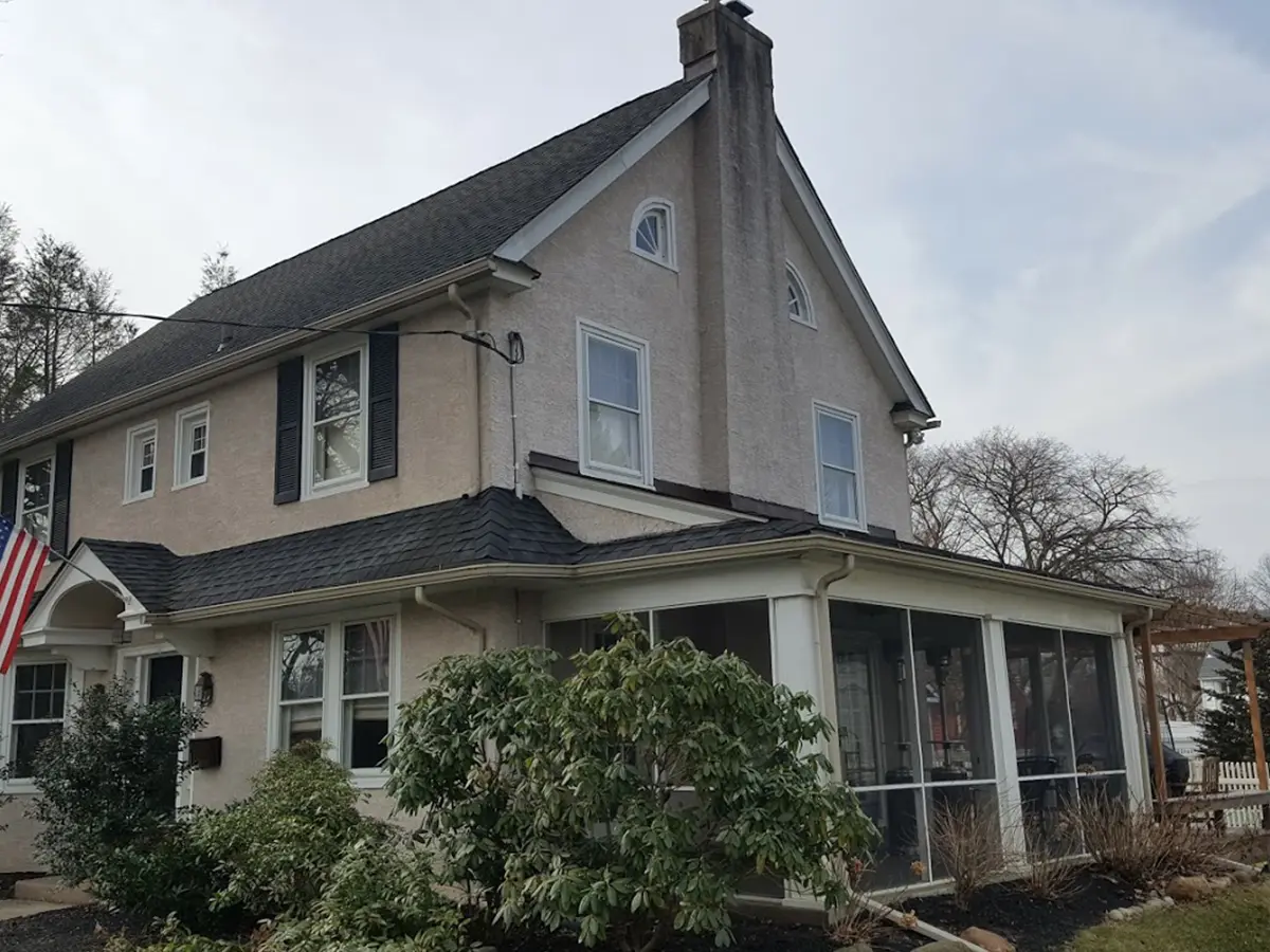 A home with a sunroom and the American flag