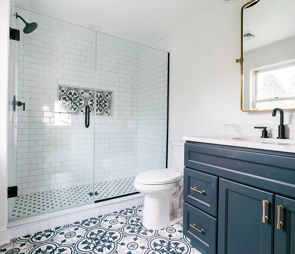 A dark blue double vanity in a bathroom with tile flooring