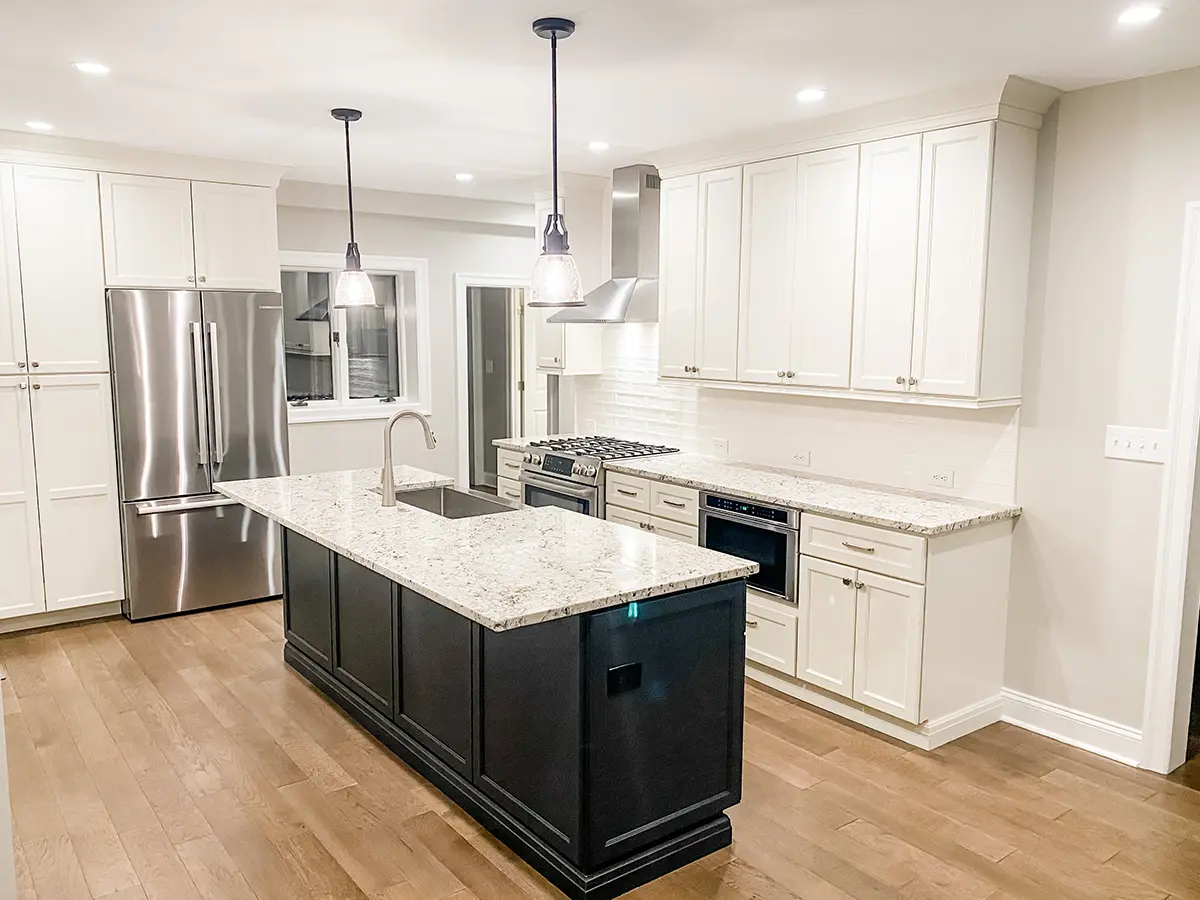 New LVP flooring, granite countertop, black island, and white cabinets for a kitchen