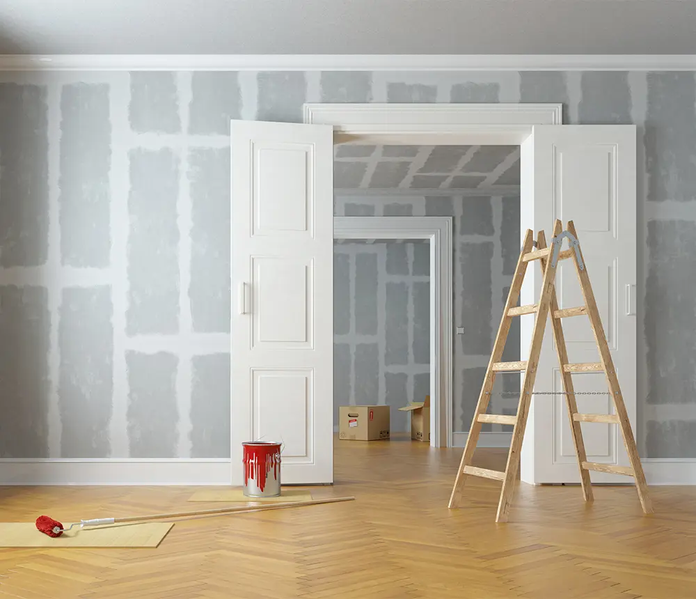 A room being remodeled with new walls and wood floor